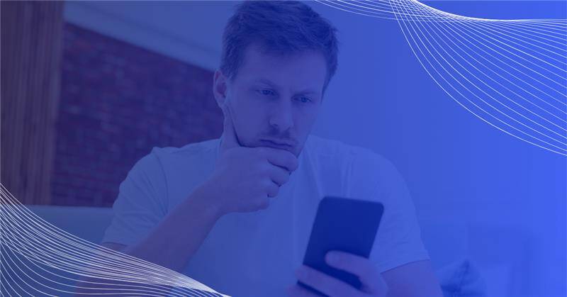 Man thinking looking at phone